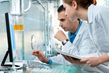 Male and female scientists at work in laboratory