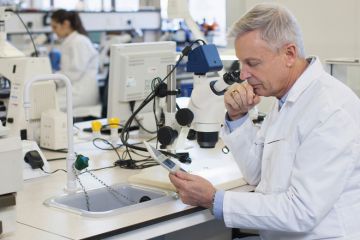 Male scientist using tablet computer in laboratory Male scientist using tablet computer in laboratory