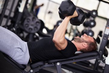 Man bench pressing with dumbbells Man bench pressing with dumbbells
