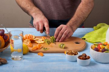 Man cutting fruit Man cutting fruit