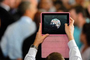 Man filming video using Apple iPad Man filming video using Apple iPad