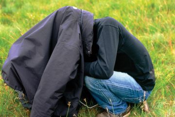 Man with head under his coat Man with head under his coat