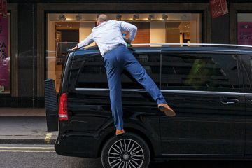 Man polishes the roof of his car Man polishes the roof of his car