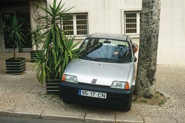 Man reverses his car into a narrow space Man reverses his car into a narrow space