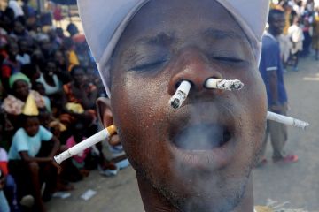 Man smoking cigarettes with ears and nostrils Man smoking cigarettes with ears and nostrils