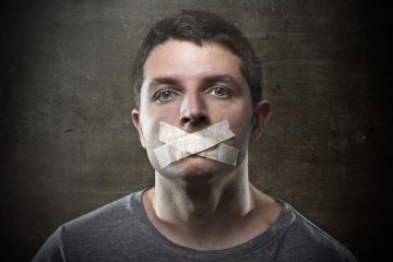 Man with tape covering mouth Man with tape covering mouth