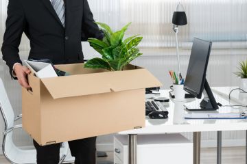 Man clearing desk