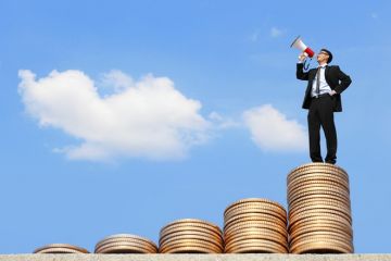 A man with a megaphone at the top of steps of coins A man with a megaphone at the top of steps of coins, symbolising student loans