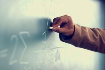 Man's hand drawing on blackboard Man's hand drawing on blackboard