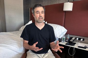 Mark Bray, a Rutgers assistant professor of history, waits in a hotel room in Newark, N.J., before a planned flight to Spain on Thursday, 9 October, 2025. Mark Bray, a Rutgers assistant professor of history, waits in a hotel room in Newark, N.J., before a planned flight to Spain on Thursday, 9 October, 2025.