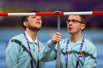 Officials measure the High Jump bar during the IAAF Athletics World Indoor Championships at Arena Birmingham, UK. To illustrate setting the bar for REF submissions..