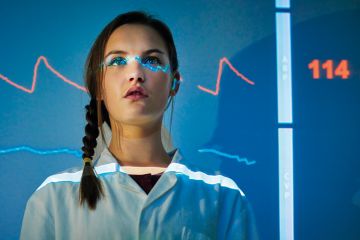 Medical science student with ECG monitor reading projected on body Medical science student with ECG monitor reading projected on body