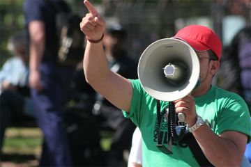 Man shouting into a megaphone Man shouting into a megaphone