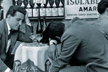 Men slumped at table Men slumped at table