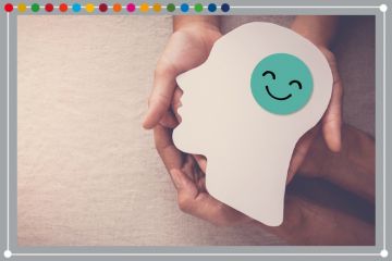 Hands holding smiling face in brain paper cutout, to illustrate mental health support. Hands holding smiling face in brain paper cutout, to illustrate mental health support.