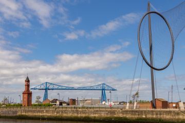 Middlesbrough, England, UK - May 14, 2016 View from the Middlehaven dock towards the transporter bridge, the old clocktower and Temenos Middlesbrough, England, UK - May 14, 2016 View from the Middlehaven dock towards the transporter bridge, the old clocktower and Temenos