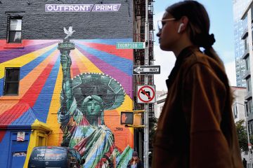 Woman walking past a mural