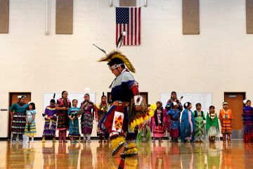 A student performs a traditional style dance in full regalia at the 21st Century Community Learning Center, USA. Students that are part of the after school learning program learn the Arapaho language, culture, history and traditions of the Arapaho tribe. A student performs a traditional style dance in full regalia at the 21st Century Community Learning Center, USA. Students that are part of the after school learning program learn the Arapaho language, culture, history and traditions of the Arapaho tribe.