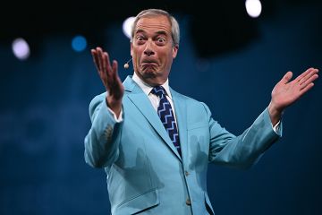 Reform UK Leader Nigel Farage reacts while performing on the first day of the Reform UK party conference at the NEC Birmingham, central England, on 5 September, 2025
