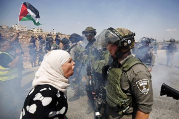 Palestinian woman argues with Israeli border policeman, West Bank Palestinian woman argues with Israeli border policeman, West Bank