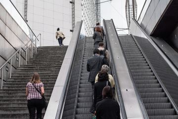 people going up escalator people going up escalator