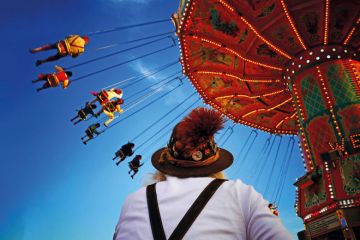 People riding on fairground ride People riding on fairground ride
