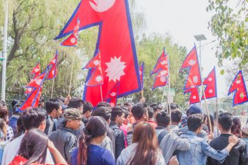 People at rally with Nepalese flags in Kathmandu People at rally with Nepalese flags in Kathmandu
