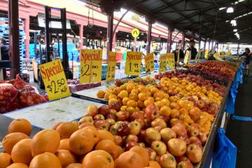Melbourne, Australia April 12, 2018 People browse the fruit and vegetable stalls at Queen Victoria Market in Melbourne. Prices are displayed over the fruit. Melbourne, Australia April 12, 2018 People browse the fruit and vegetable stalls at Queen Victoria Market in Melbourne. Prices are displayed over the fruit.