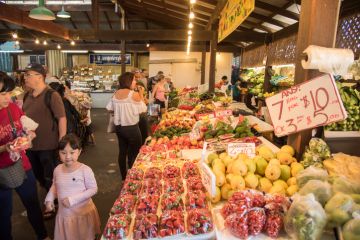 People shopping in the fresh fruit and vegetable stalls at the Fremantle Markets in Fremantle, Western Australia