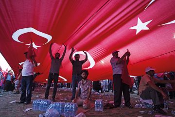 People underneath a Turkish flag People underneath a Turkish flag