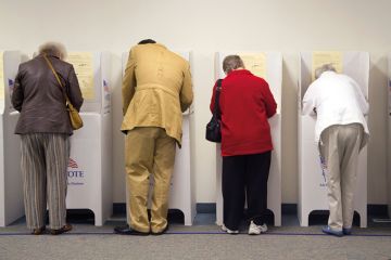 A row of people voting
