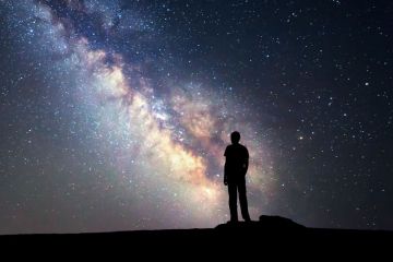 Person looking at starry night sky Person looking at starry night sky