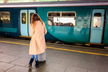 Person waiting for a train at Cardiff Central Station