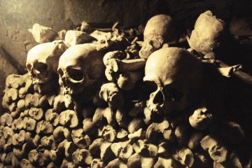 Pile of skulls and bones in French catacombs Pile of skulls and bones in French catacombs