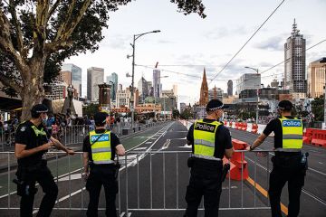 Members of Victoria Police patrol St. Kilda Road, Melbourne