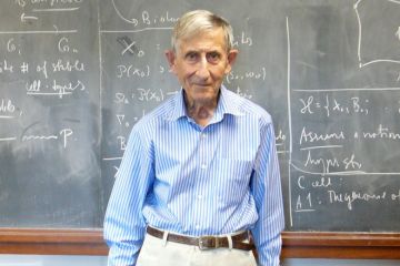 Professor Freeman Dyson standing in front of lecture hall blackboard Professor Freeman Dyson standing in front of lecture hall blackboard