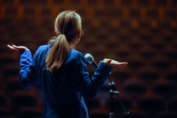 A public speaker shrugs A public speaker shrugs