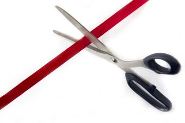scissors cutting red tape
