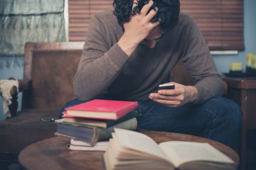 Man revising with books Man revising with books