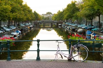 Sad bicycle on a bridge in Amsterdam, early in the morning