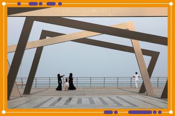 Women wearing chadors walk past an art installation on the corniche promenade in Dhahran, Saudi Arabia. Women wearing chadors walk past an art installation on the corniche promenade in Dhahran, Saudi Arabia.
