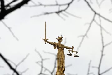 A statue of the scales of justice stands above the Old Bailey, London. To illustrate A statue of the scales of justice stands above the Old Bailey, London. To illustrate