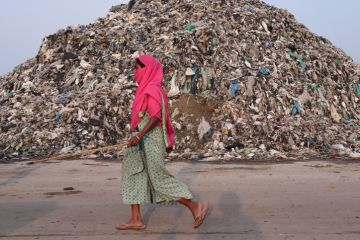 Scavengers next to a garbage-heap at Boragaon dumping site, on the eve of World Environment Day, in Guwahati, Assam, India on Friday, June 4, 2021