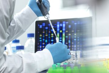 Scientist pipetting sample into a vial for DNA testing Scientist pipetting sample into a vial for DNA testing