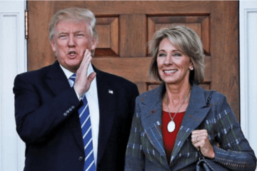Donald Trump standing with Betsy DeVos