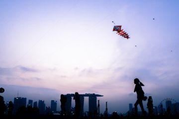 Singapore, Singapore - August 22th, 2015 The kids are playing with the kite on top of the Marina Barrage.