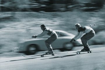 Skiers racing car down hill Skiers racing car down hill
