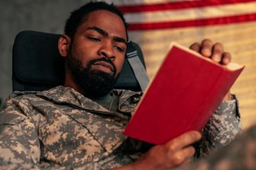 A soldier reading a book A soldier reading a book