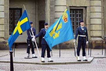 Soldiers with flags at the courtyard of the Royal Palace in Stockholm, Sweden