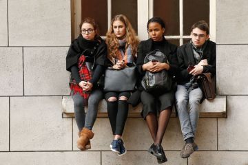Sorbonne University students sitting on window ledge Sorbonne University students sitting on window ledge
